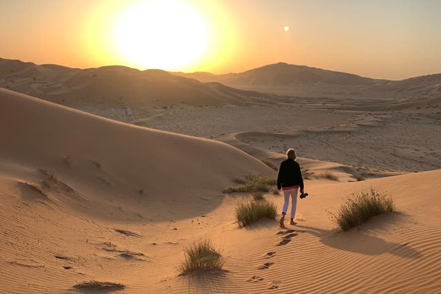 <p>Shoes go first: A fellow member of the tour group stretches her toes in the desert sand </p>