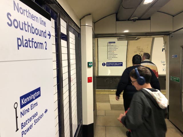 <p>Where next? Travellers at Kennington station in south London waiting for the first train to Battersea Power Station</p>