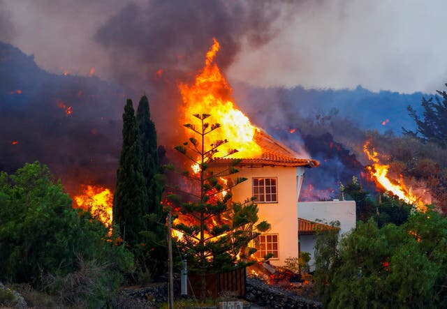 <p>A house burns due to lava from the eruption of a volcano in the Cumbre Vieja national park on the Canary Island of La Palma</p>