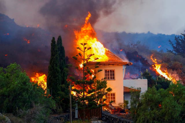 <p>A house burns due to lava from the eruption of a volcano in the Cumbre Vieja national park on the Canary Island of La Palma</p>