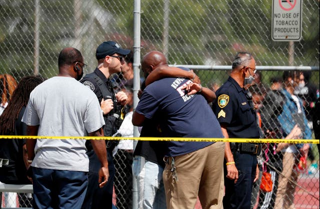 <p>People embrace outside Heritage High School as Newport News Police are on scene responding to a shooting incident Monday, Sept. 20, 2021 in Newport News, Va. </p>