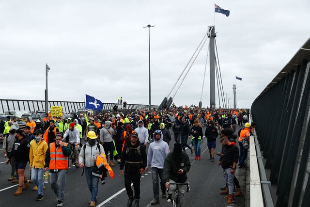 <p>Construction workers and demonstrators attend a protest against Covid-19 regulations in Melbourne on 21 September 2021</p>