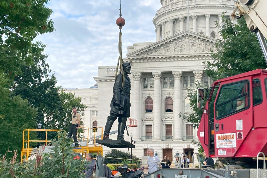 Workers reinstall Wisconsin statues downed in 2020 protest
