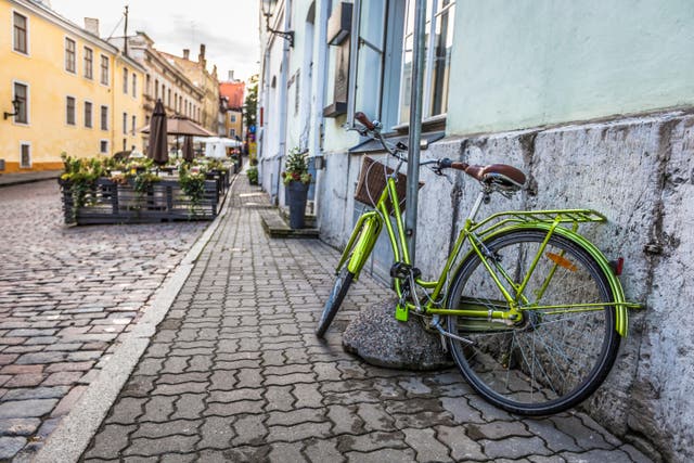 Cycling through Tallinn, Estonia (Alamy/PA)