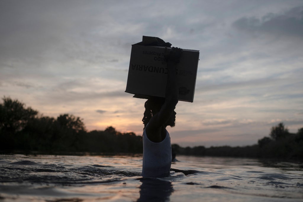 Harrowing photos at Texas border show desperate Haitian migrants crossing river with belongings Harrowing photos at Texas border show desperate Haitian migrants crossing river with belongings