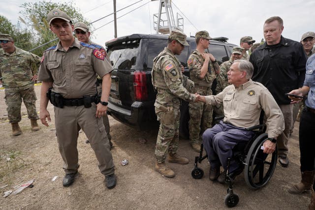 <p>Texas Gov. Greg Abbott, right, shakes a National Guard member’s hand after speaking during a news conference along the Rio Grande </p>