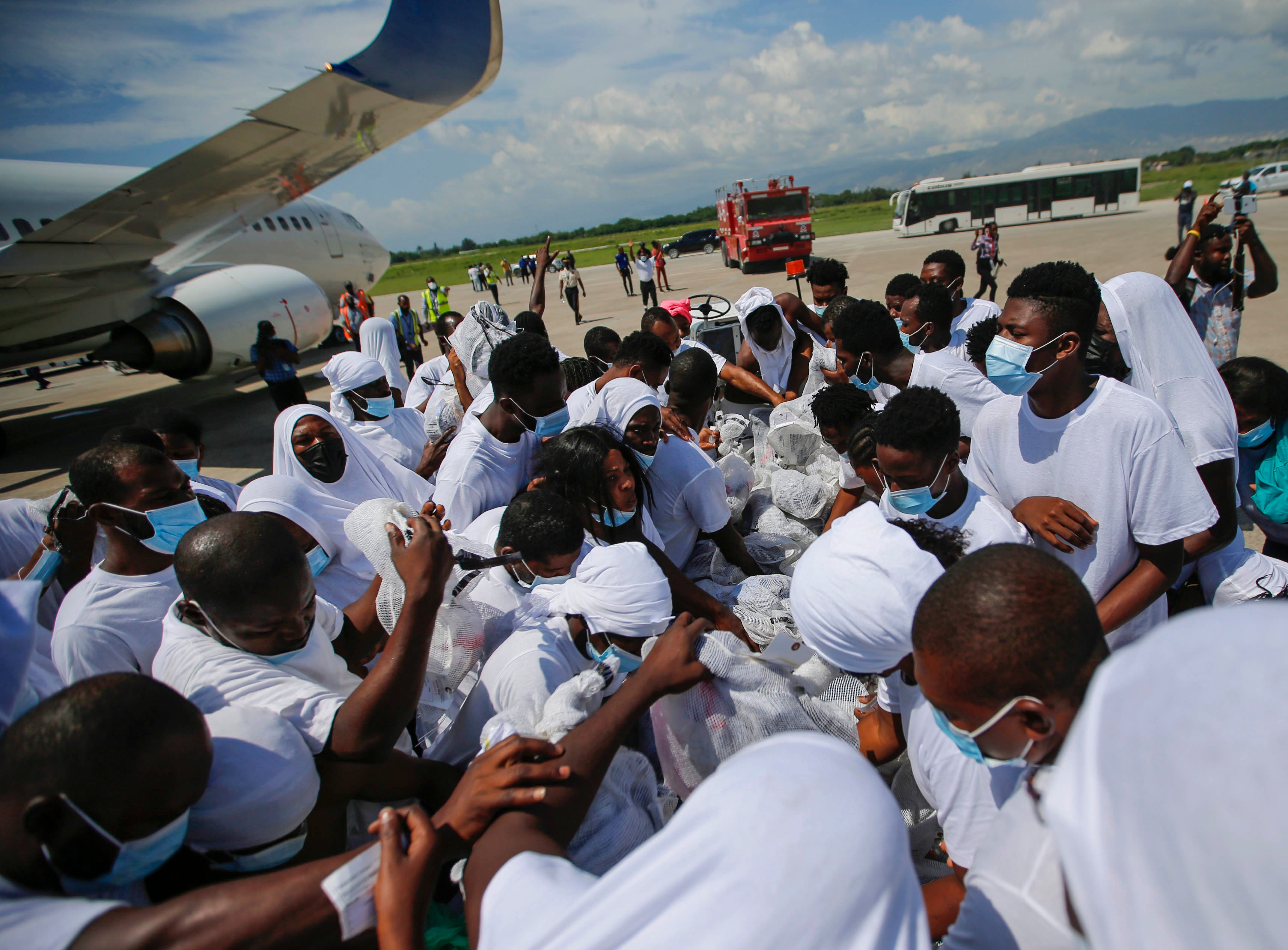 Haitians deported from the United States recover their belongings on the tarmac of the Toussaint Louverture airport in Port-au-Prince, Haiti Tuesday, 21 September 2021