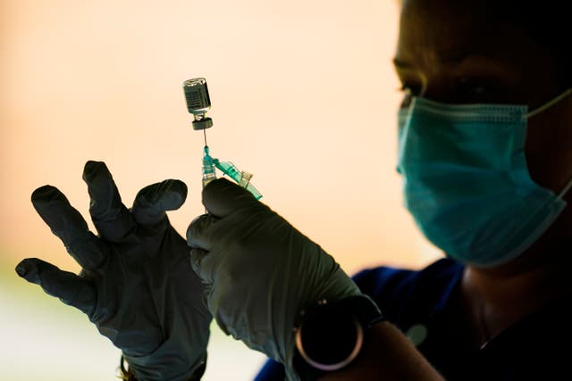 <p>A health worker prepares a dose of the Pfizer coronavirus vaccine. </p>