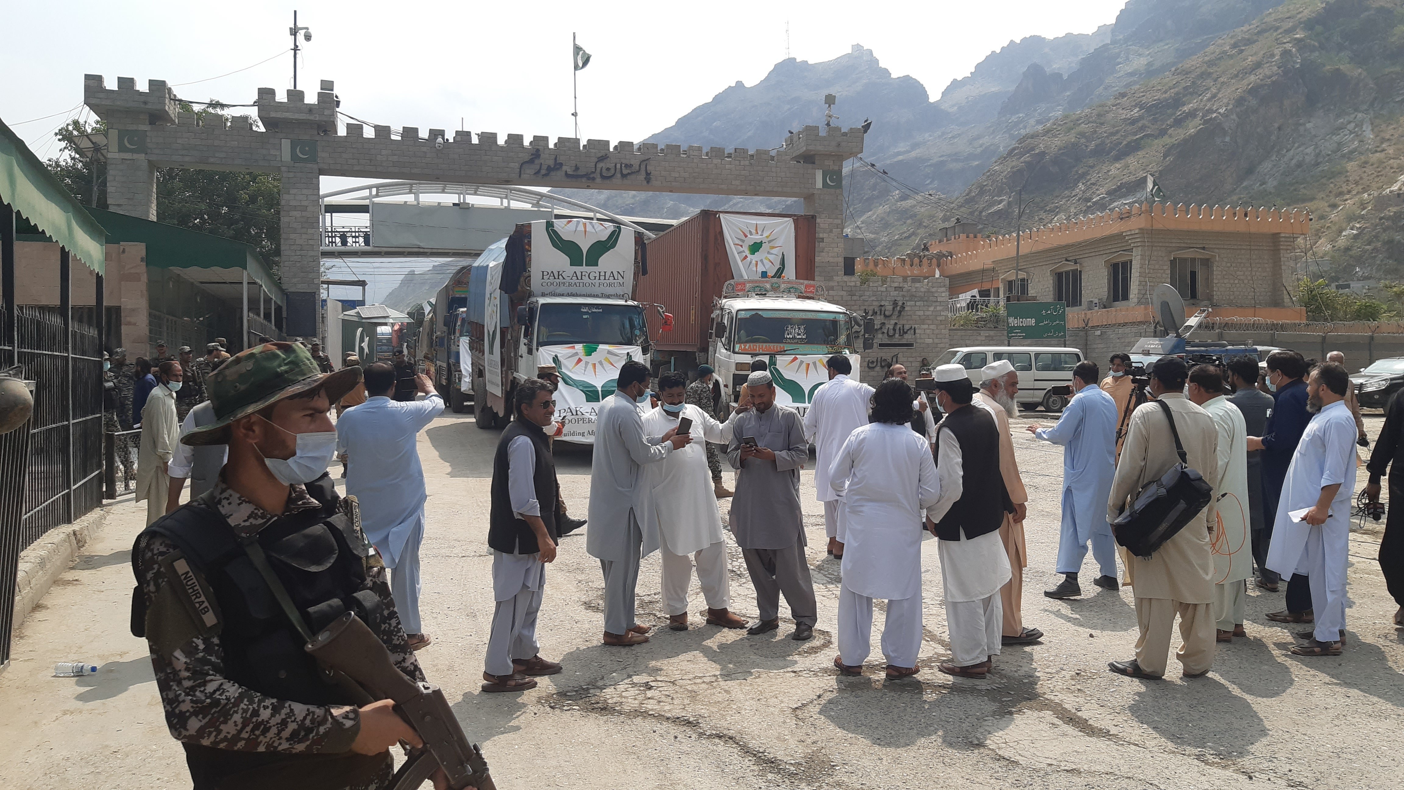 Taliban and Pakistani security keep guard at Torkham border crossing as Afghans wait for the reopening of the border gate to enter Pakistan