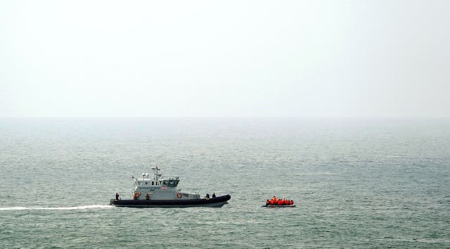 <p>A Border Force vessel intercepts a group of people thought to be migrants in a small boat off the coast of Dover in Kent</p>