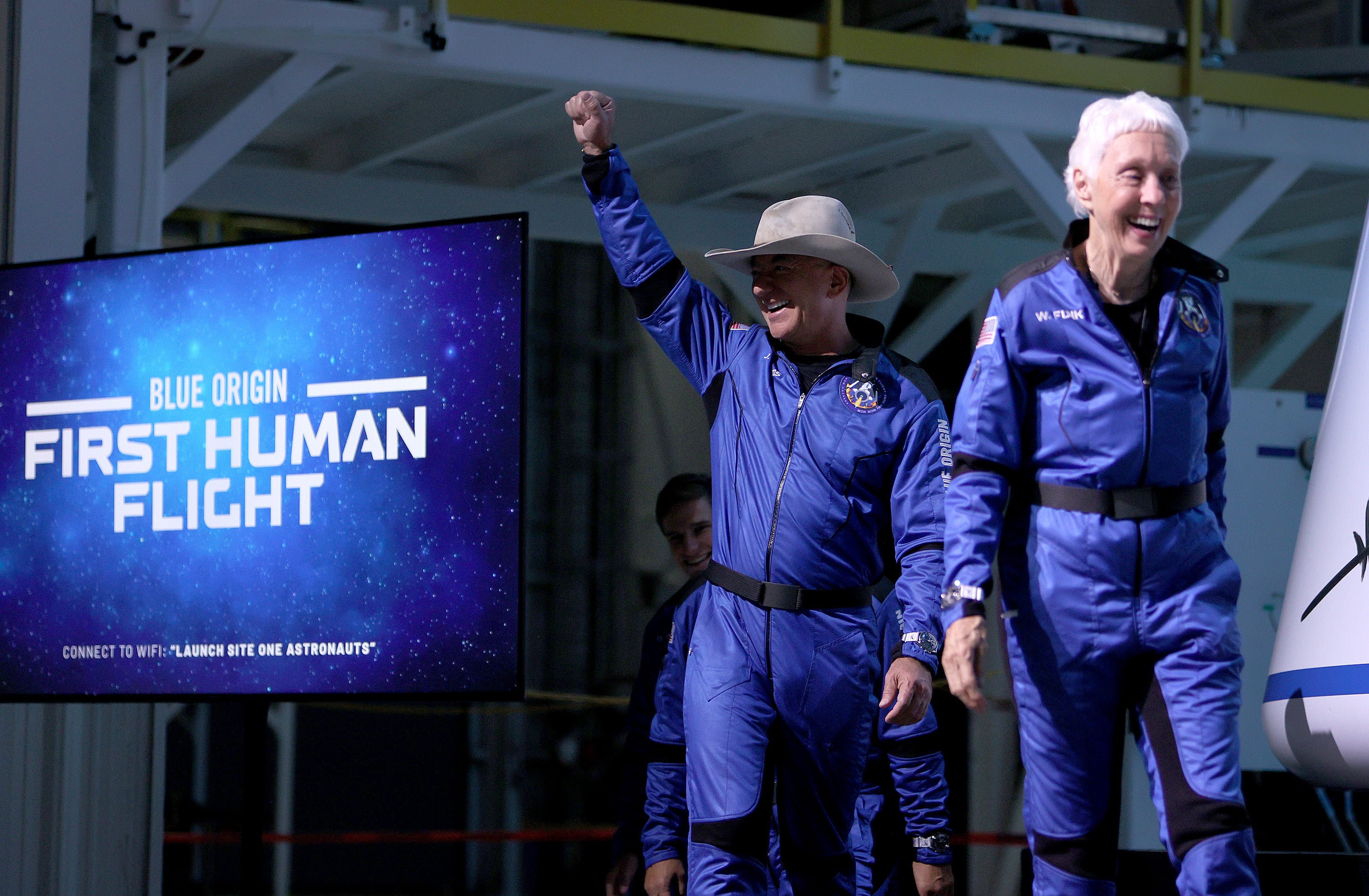 Blue Origin’s New Shepard crew (L-R) Jeff Bezos and Wally Funk arrive for a press conference after flying into space in the Blue Origin New Shepard rocket