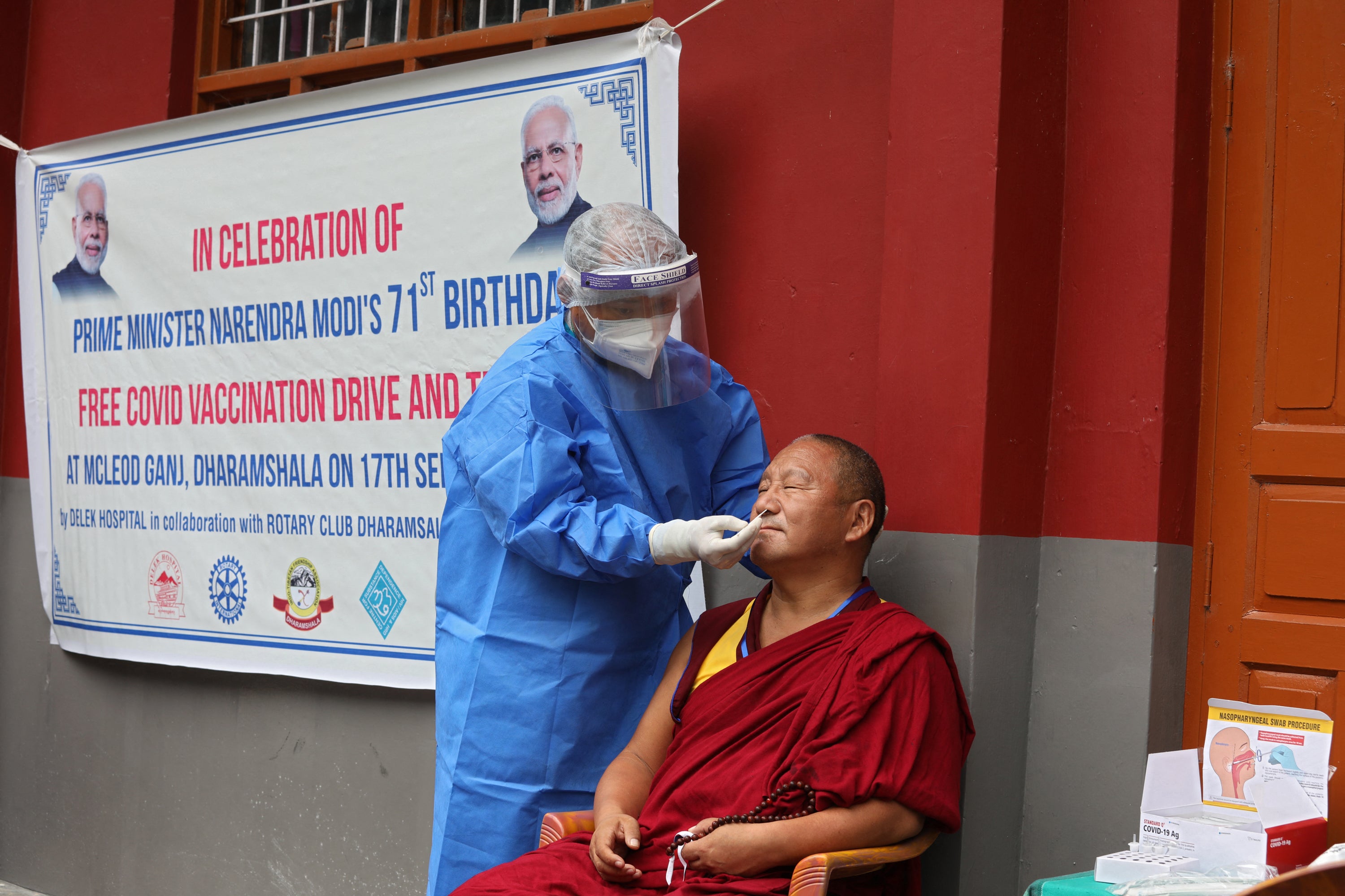 A health worker takes a nasal swab sample from a Tibetan monk in India at a free Covid vaccination and testing drive organised to mark Indian prime minister Narendra Modi’s 71st birthday