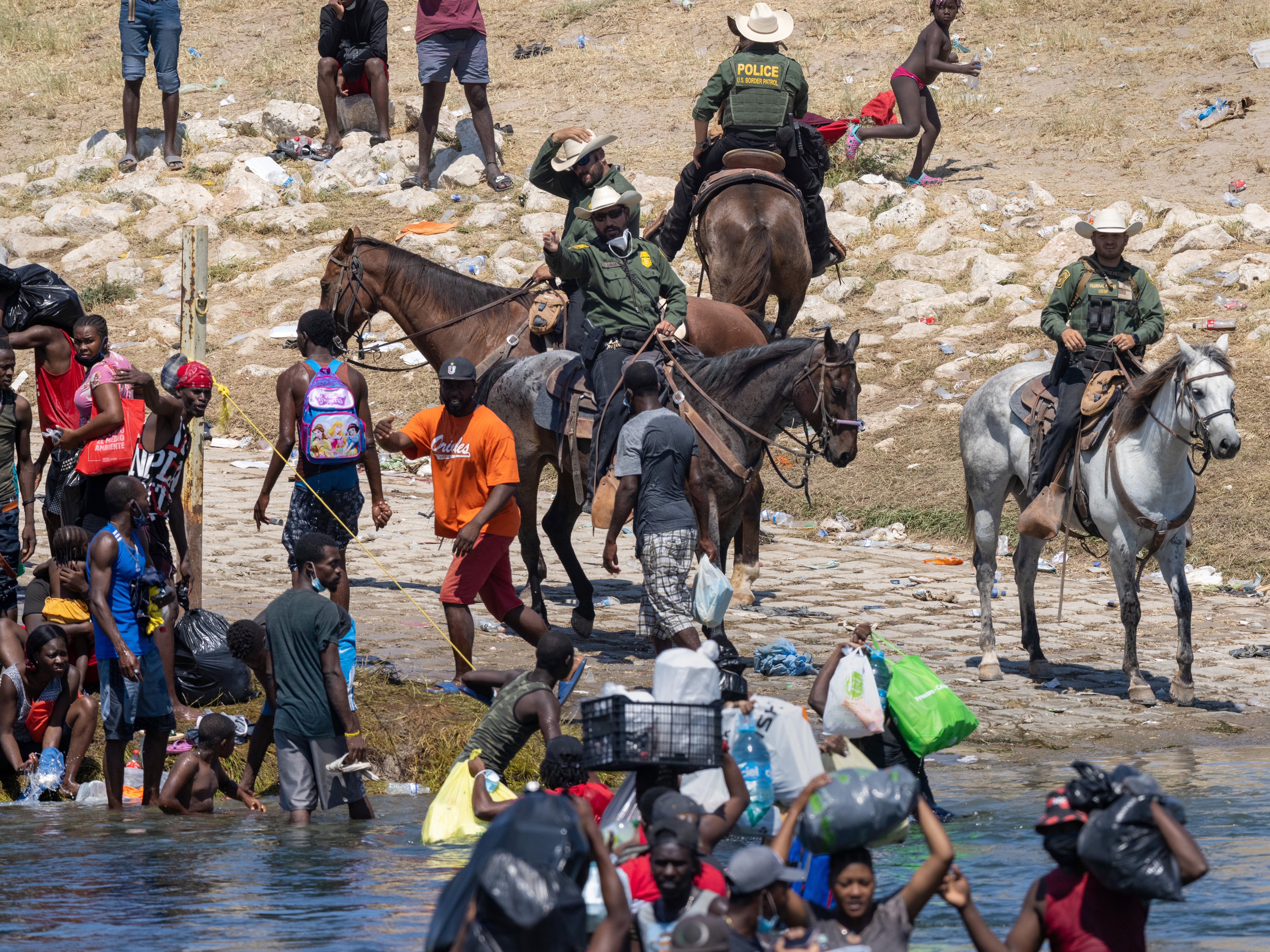 Migrants interact with Border Patrol agents