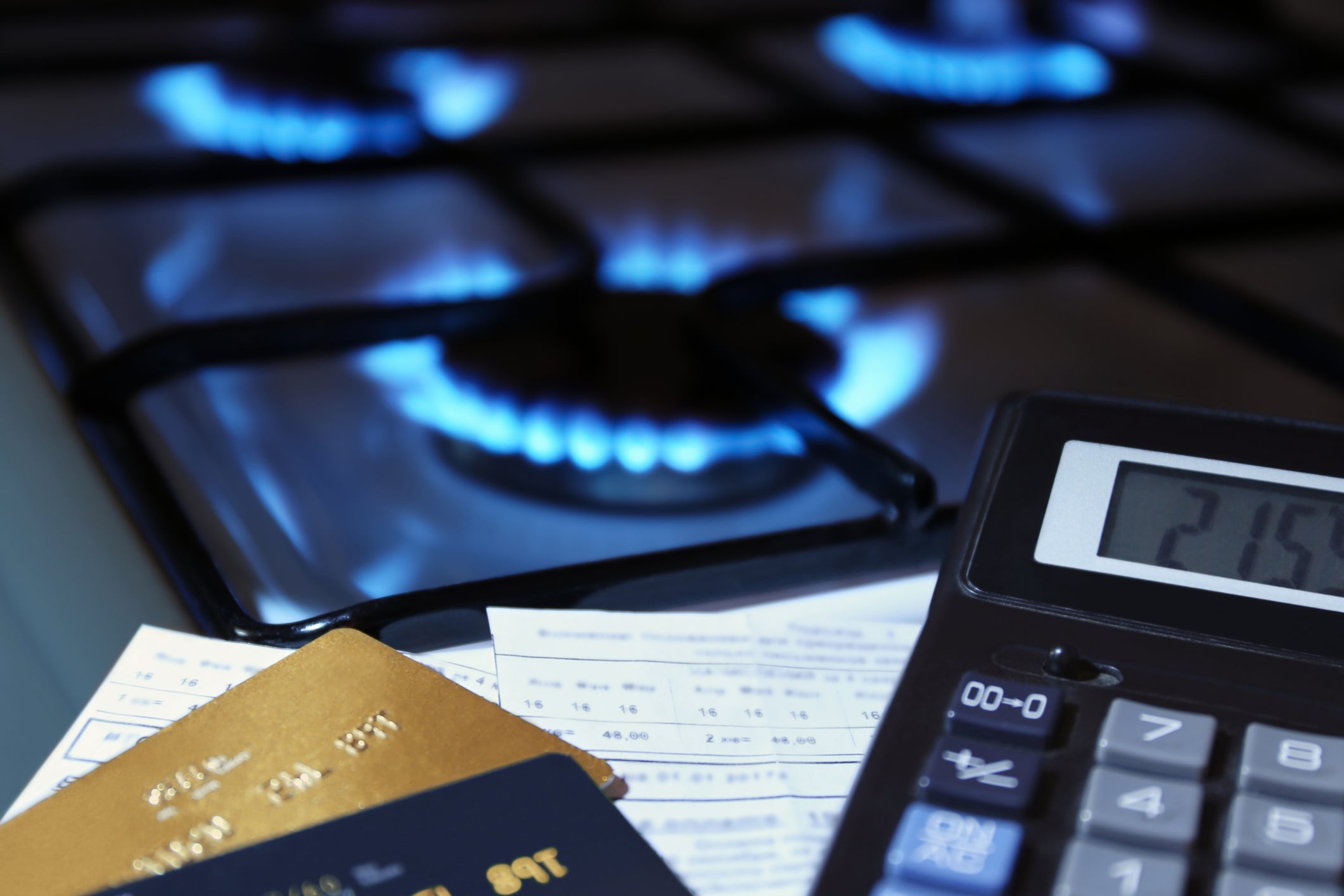 Bank card, calculator and burning gas stove