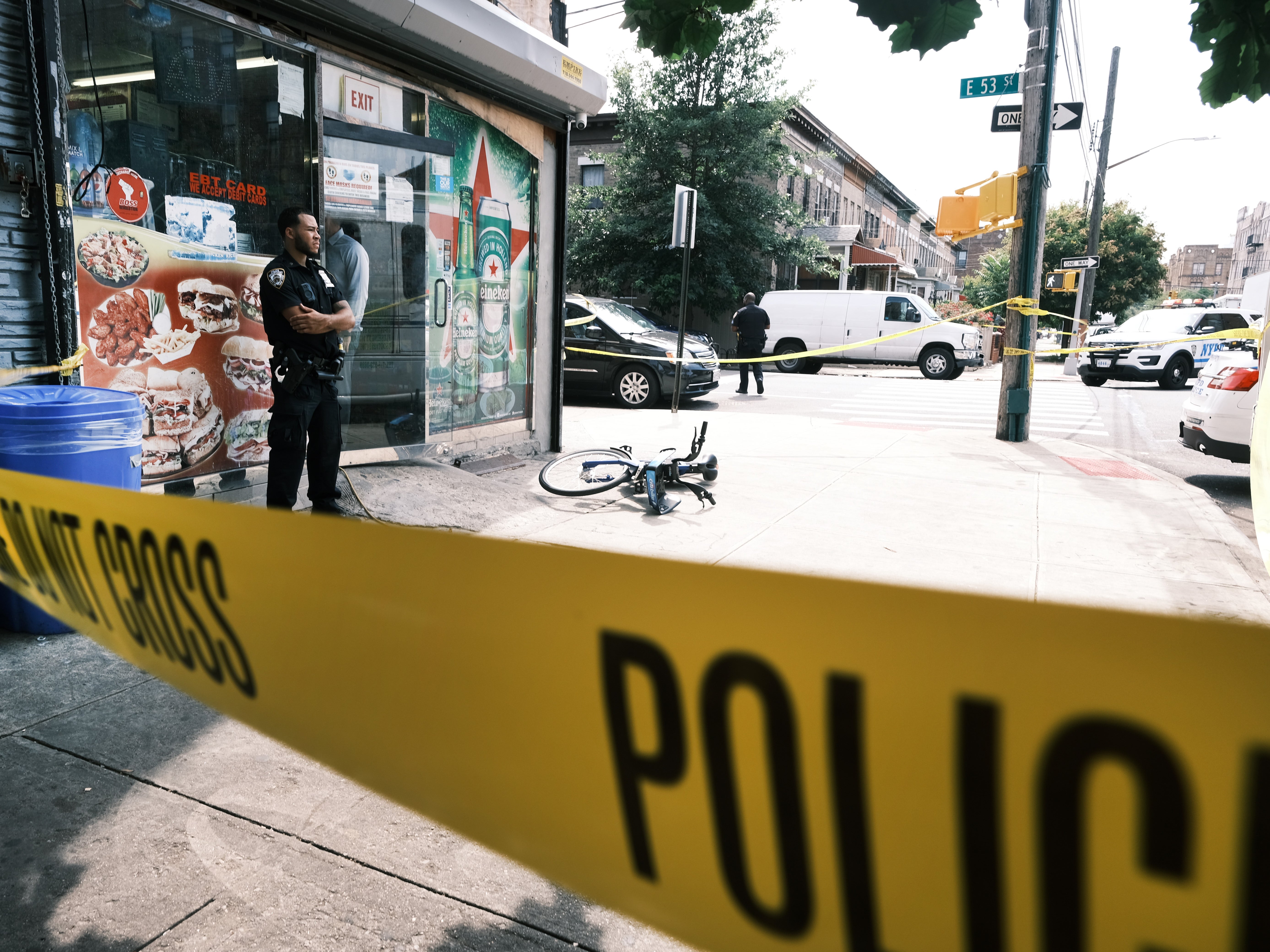 <p>Police converge on the scene of a shooting in Brooklyn, one of numerous during the day, on July 14, 2021 in New York City</p>