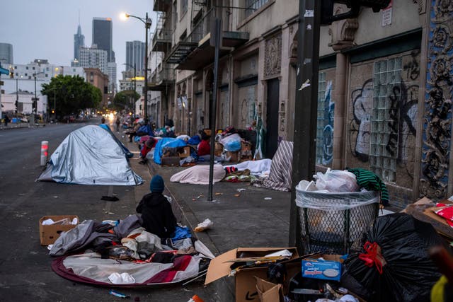 <p>As the sun starts to rise at dawn people start to wake up and move around in skid row on Wednesday, May 12, 2021 in Los Angeles, CA</p>