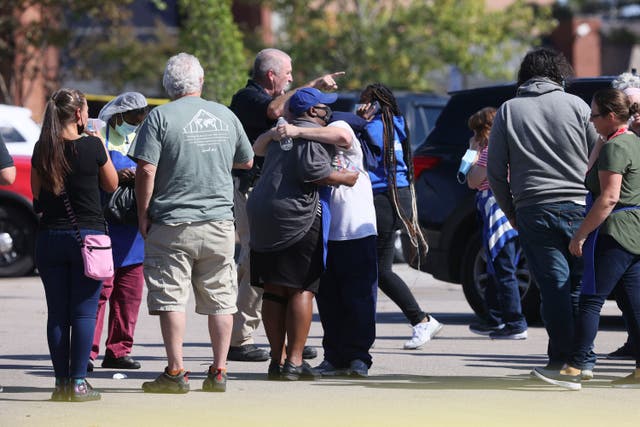 <p>People embrace as police respond to the scene of a shooting at a Kroger’s grocery store in Collierville, Tennessee</p>