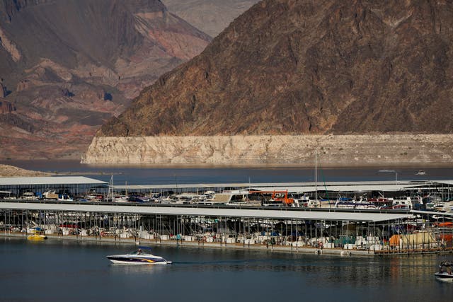 <p>A 2020 photo of a bathtub ring of light minerals delineating the high water mark on Lake Mead. The government released projections Wednesday that indicate an even more troubling outlook for a river that serves millions of people in the U.S. West</p>