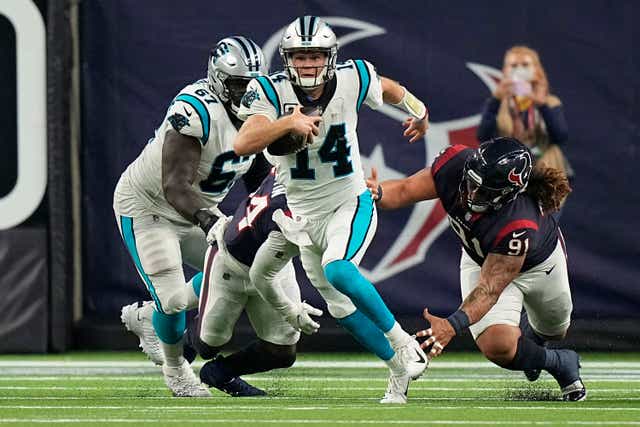 Carolina Panthers quarterback Sam Darnold breaks away from Houston Texans defensive tackle Roy Lopez (Eric Christian Smith/AP)