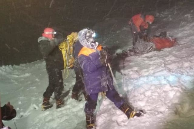 <p>Rescuers on Mount Elbrus after a group of climbers was struck by severe weather conditions while at an altitude of over 16,000ft </p>