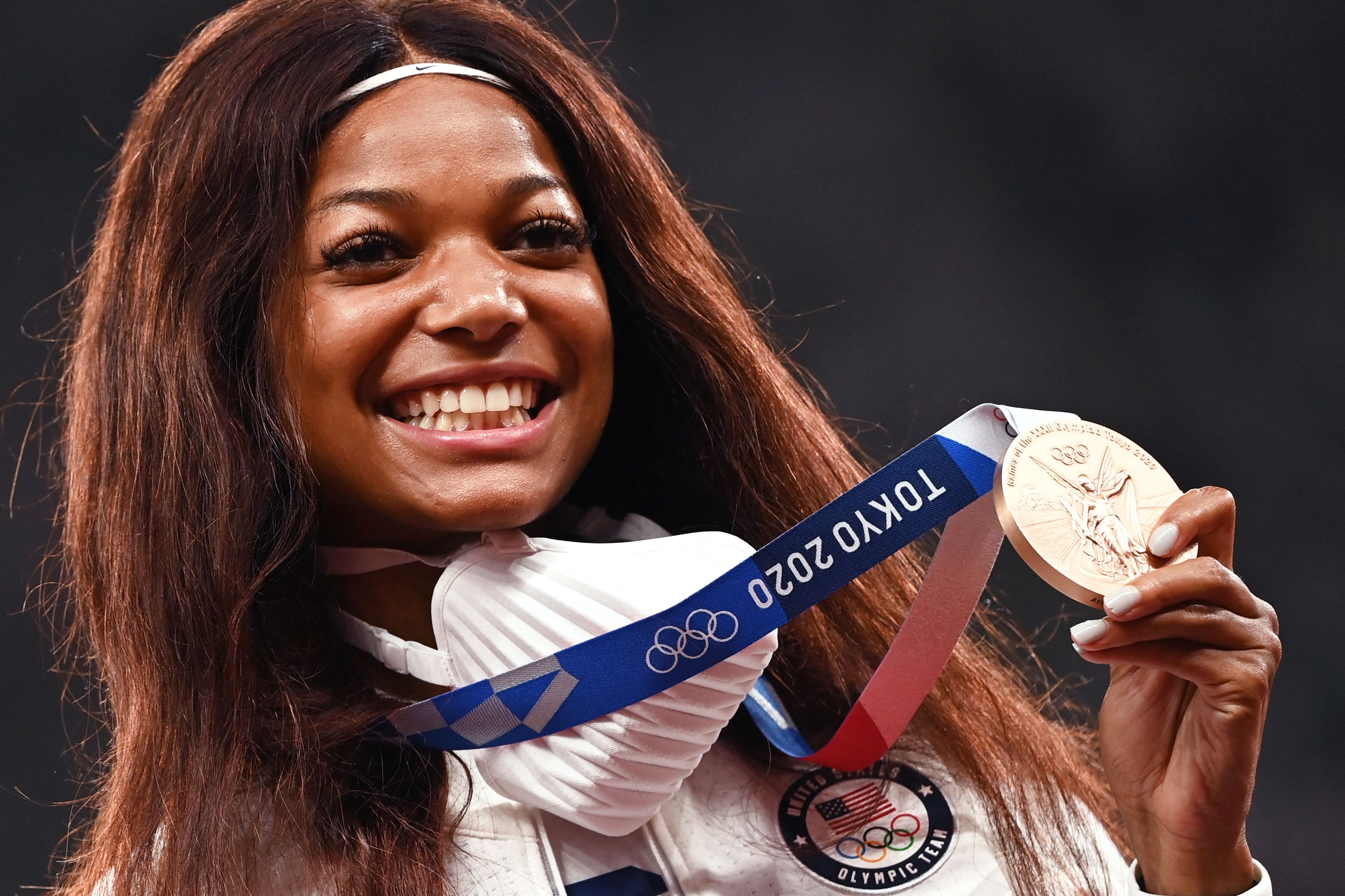 Bronze medallist Gabby Thomas celebrates during the medal ceremony for the women’s 200m event