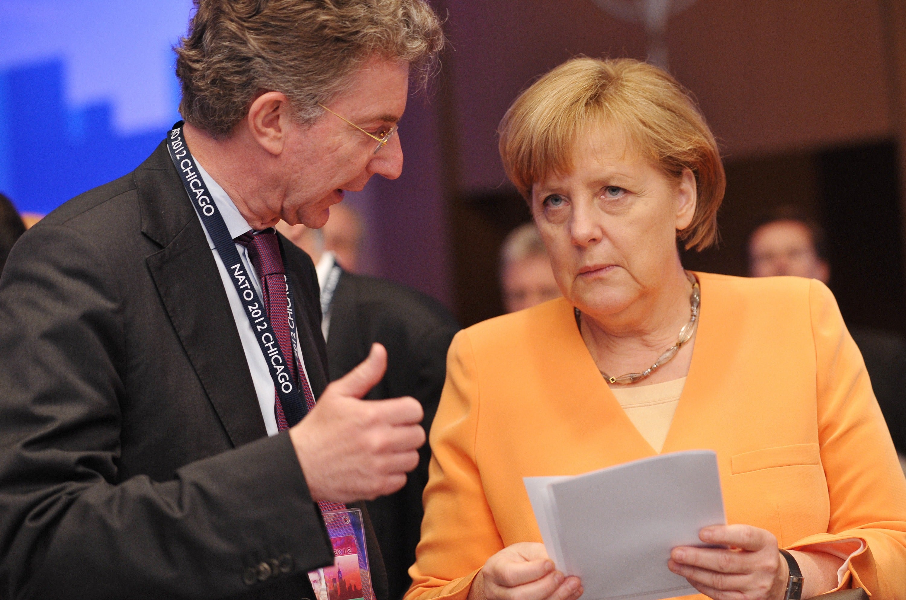 German Chancellor Angela Merkel chats with Christoph Heusgen at a Nato summit