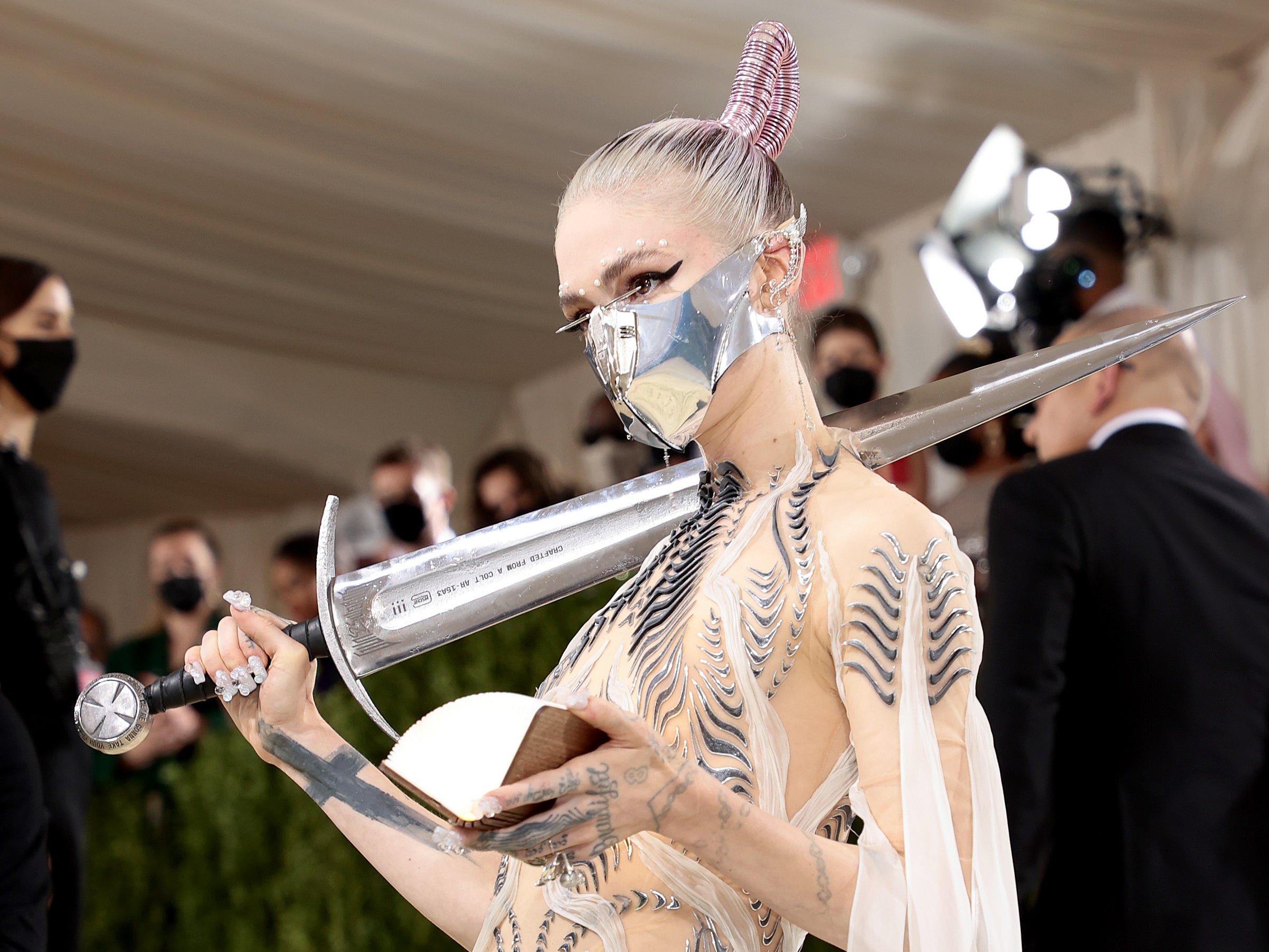 Grimes with the sword that initially barred entry to the 2021 Met Gala