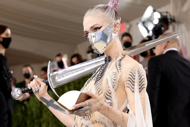 <p>Grimes with the sword that initially barred entry to the 2021 Met Gala</p>