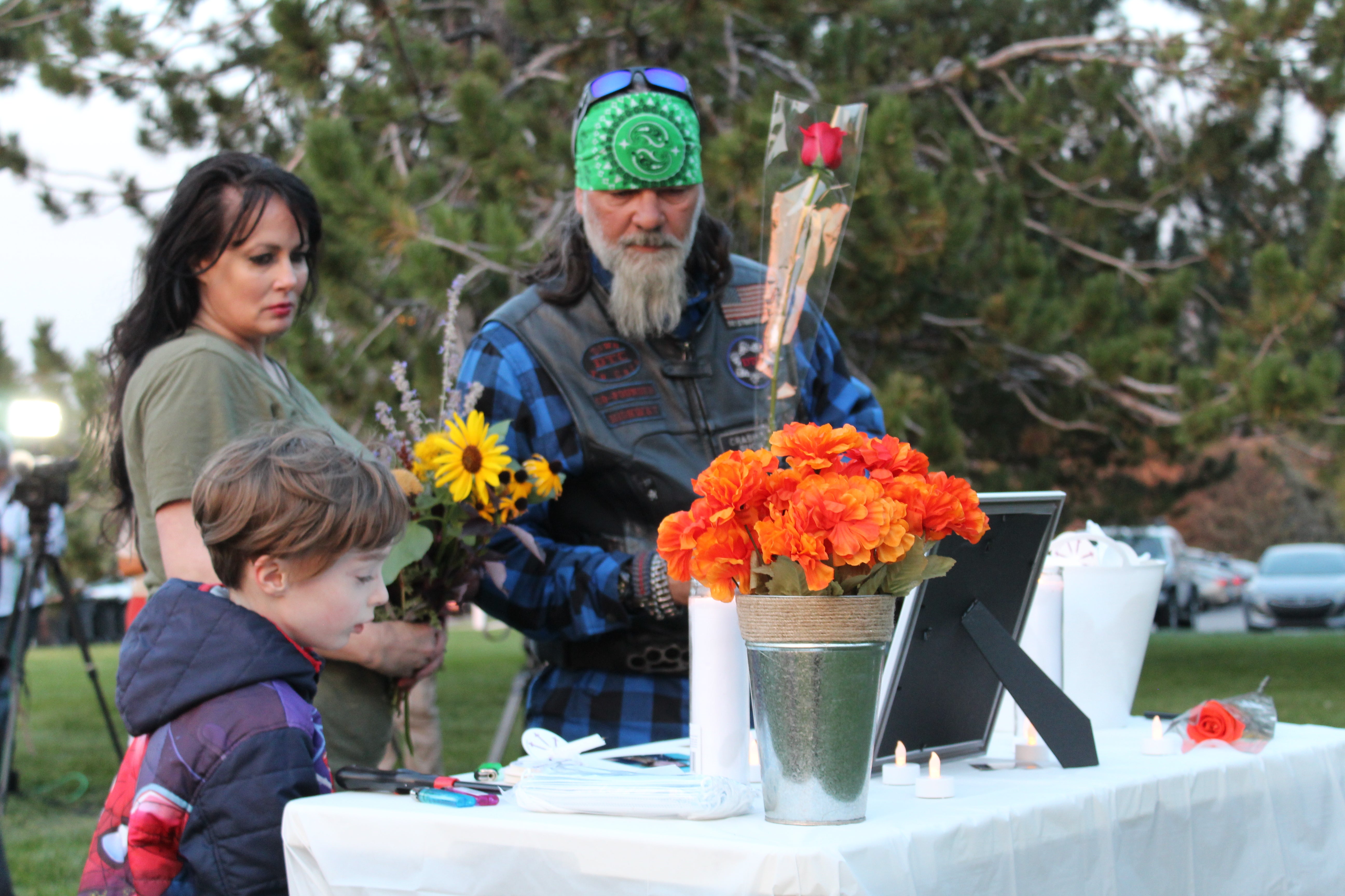 A couple and their young son pay their respects during a vigil for Gabby Petito in Salt Lake City, Utah