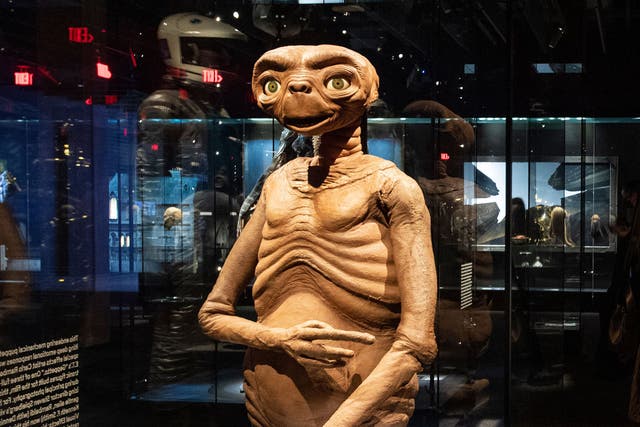 <p>Artefacts of cinema, from such films as ‘ET’ and ‘Star Wars’ are displayed inside the Academy Museum Of Motion Pictures</p>