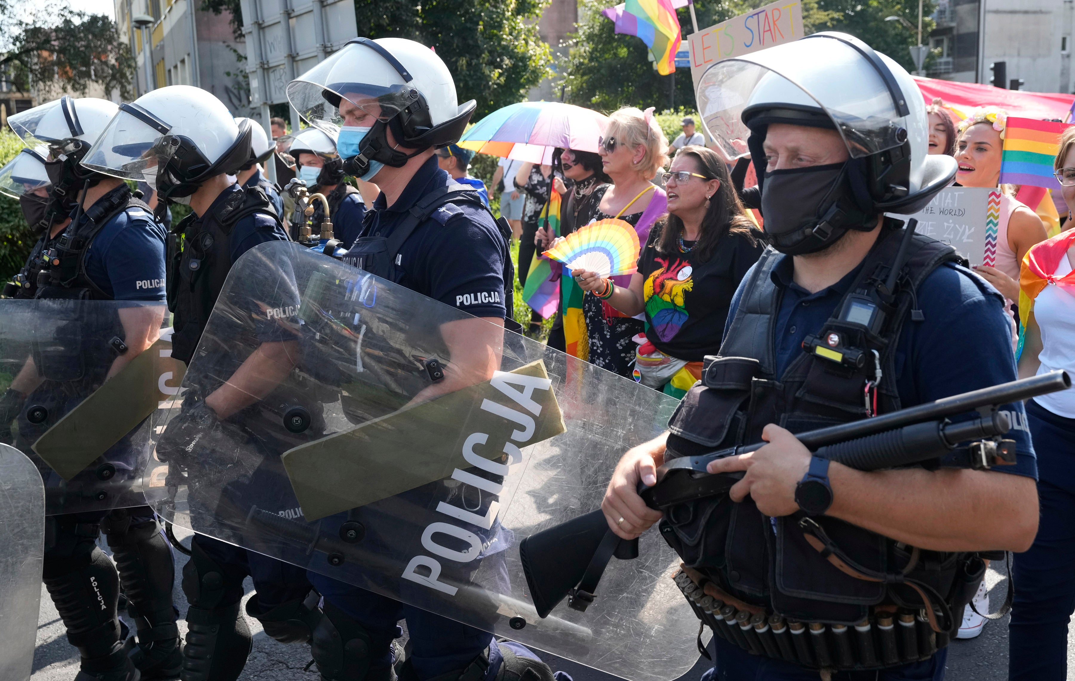 LGBT marchers with parade with rainbow flags in Poland amid heavy police presence