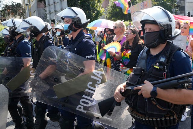 <p>LGBT marchers with parade with rainbow flags in Poland amid heavy police presence </p>