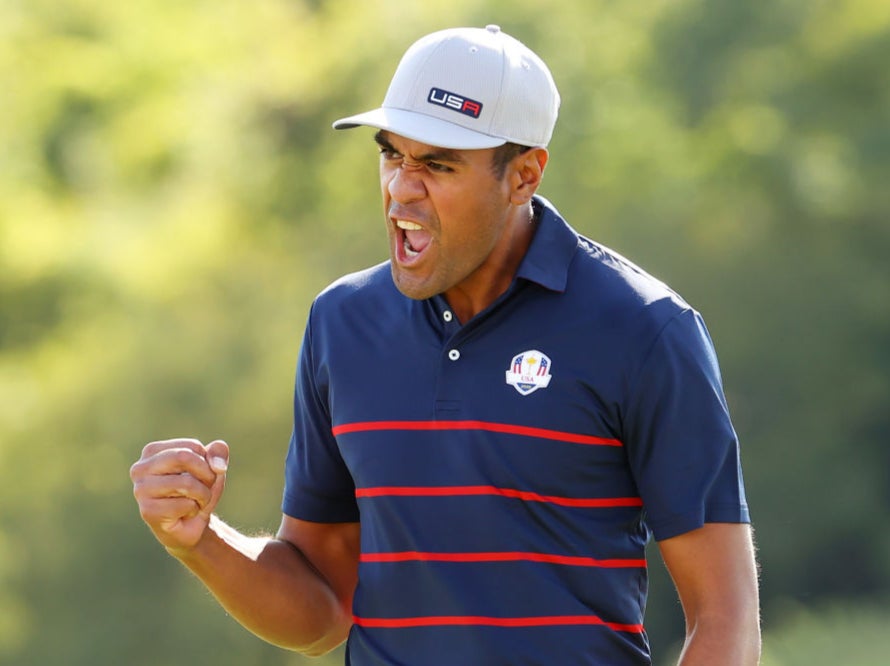 Tony Finau celebrates during a one-sided victory over McIlroy and Shane Lowry