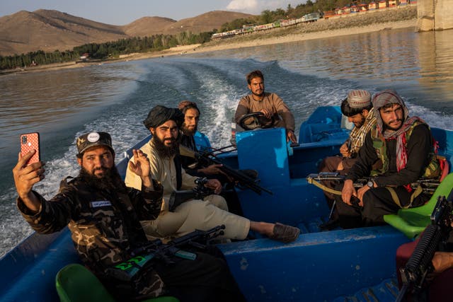 <p>File: Taliban fighters on a boat ride in the Qargha dam on the outskirts of Kabul on 24 September</p>
