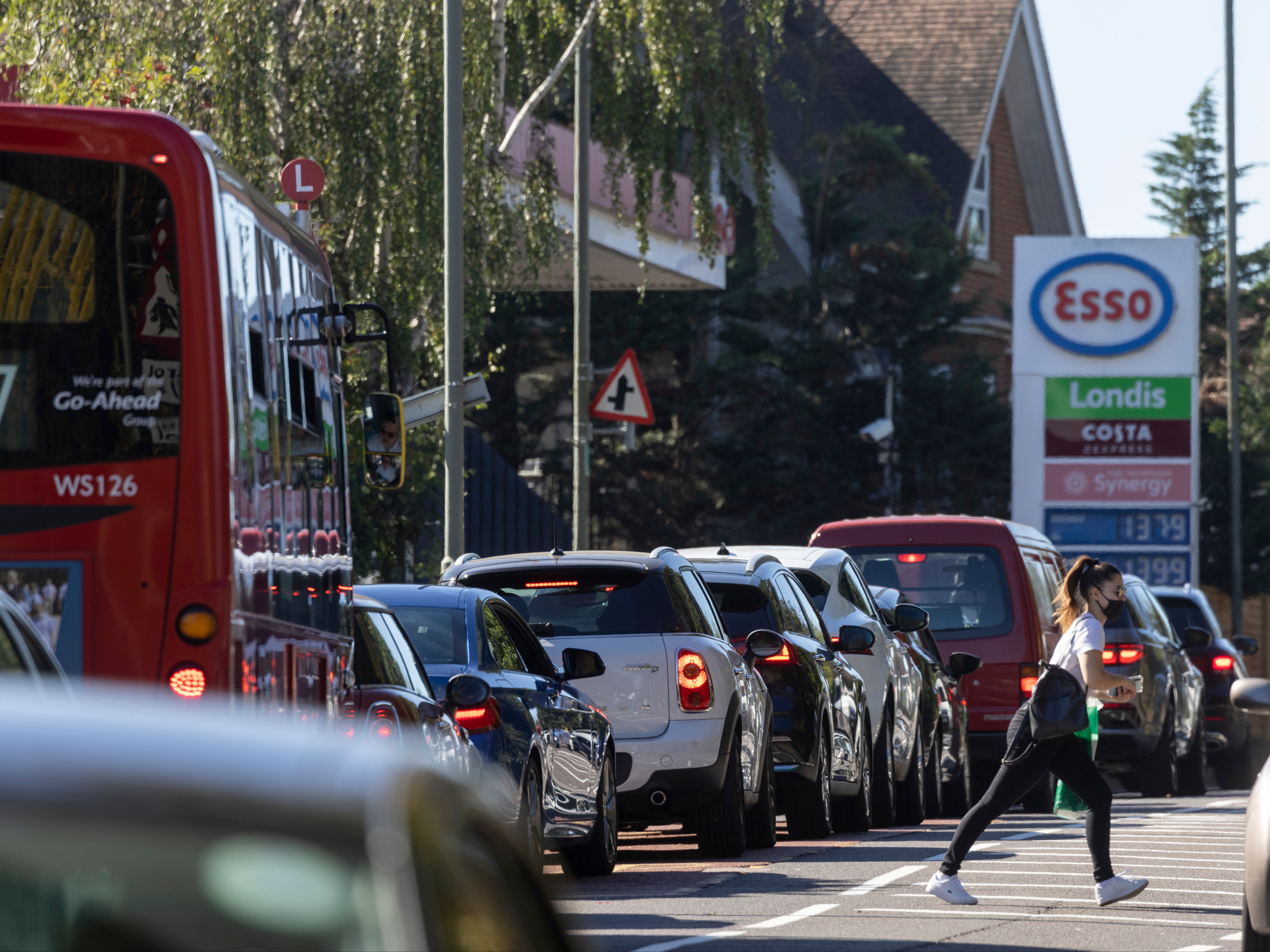 A queue forms for an Esso petrol station in London