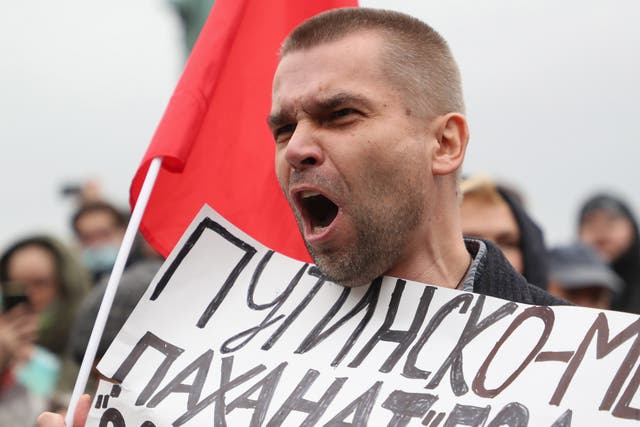 <p>A Russian Communist party supporter at the protest against election fraud in Moscow on Saturday</p>