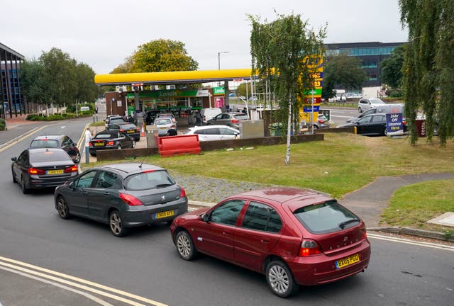 <p>Motorists queue for fuel at a petrol station </p>