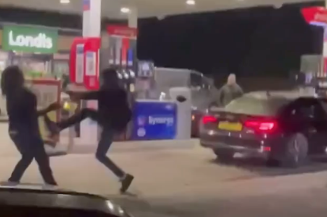 <p>Two men fighting at a petrol station in Chichester on 25 September 2021</p>