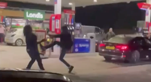 <p>Two men fighting at a petrol station in Chichester on 25 September 2021</p>