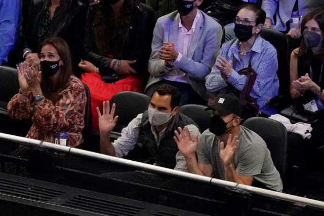 Roger Federer, centre, waves to the crowd while watching the Laver Cup (Elise Amendola/AP)