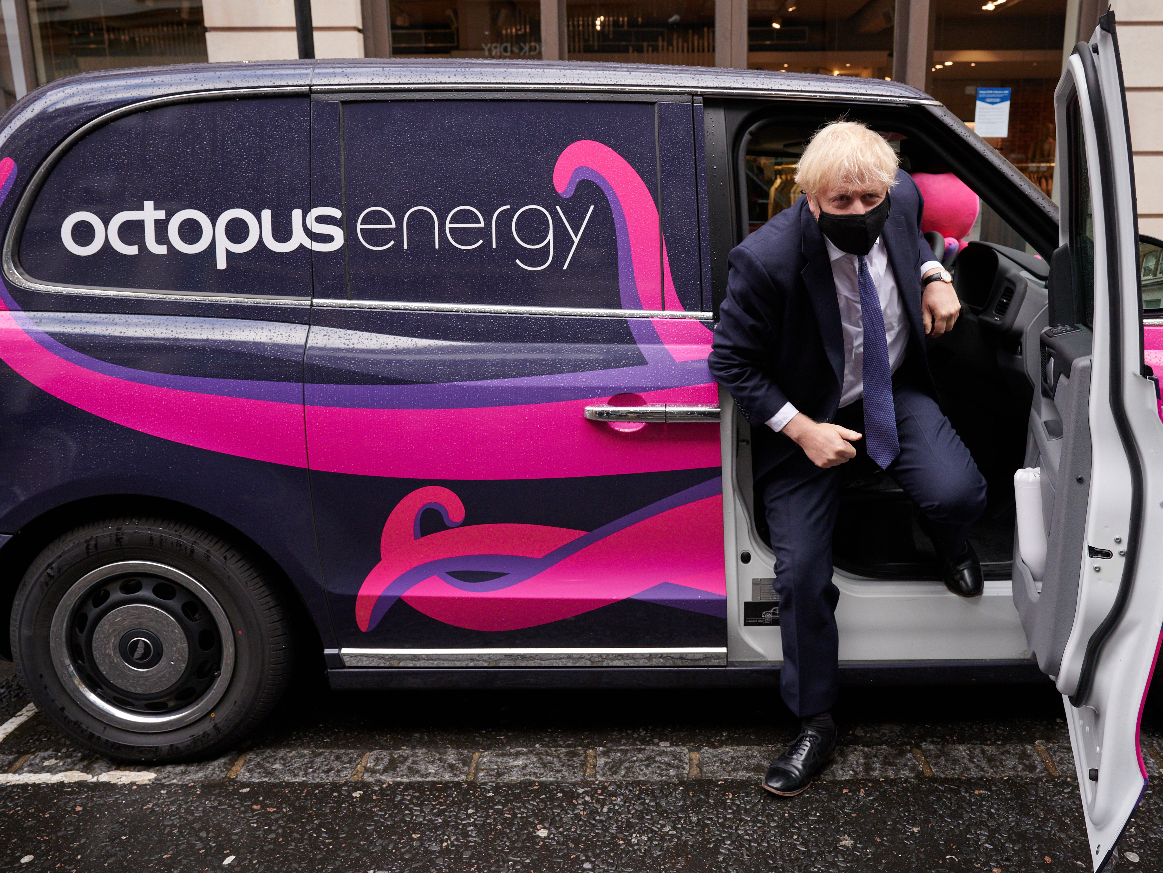The file photo from October 2020 shows Boris Johnson posing for photographs as he visits the headquarters of Octopus Energy