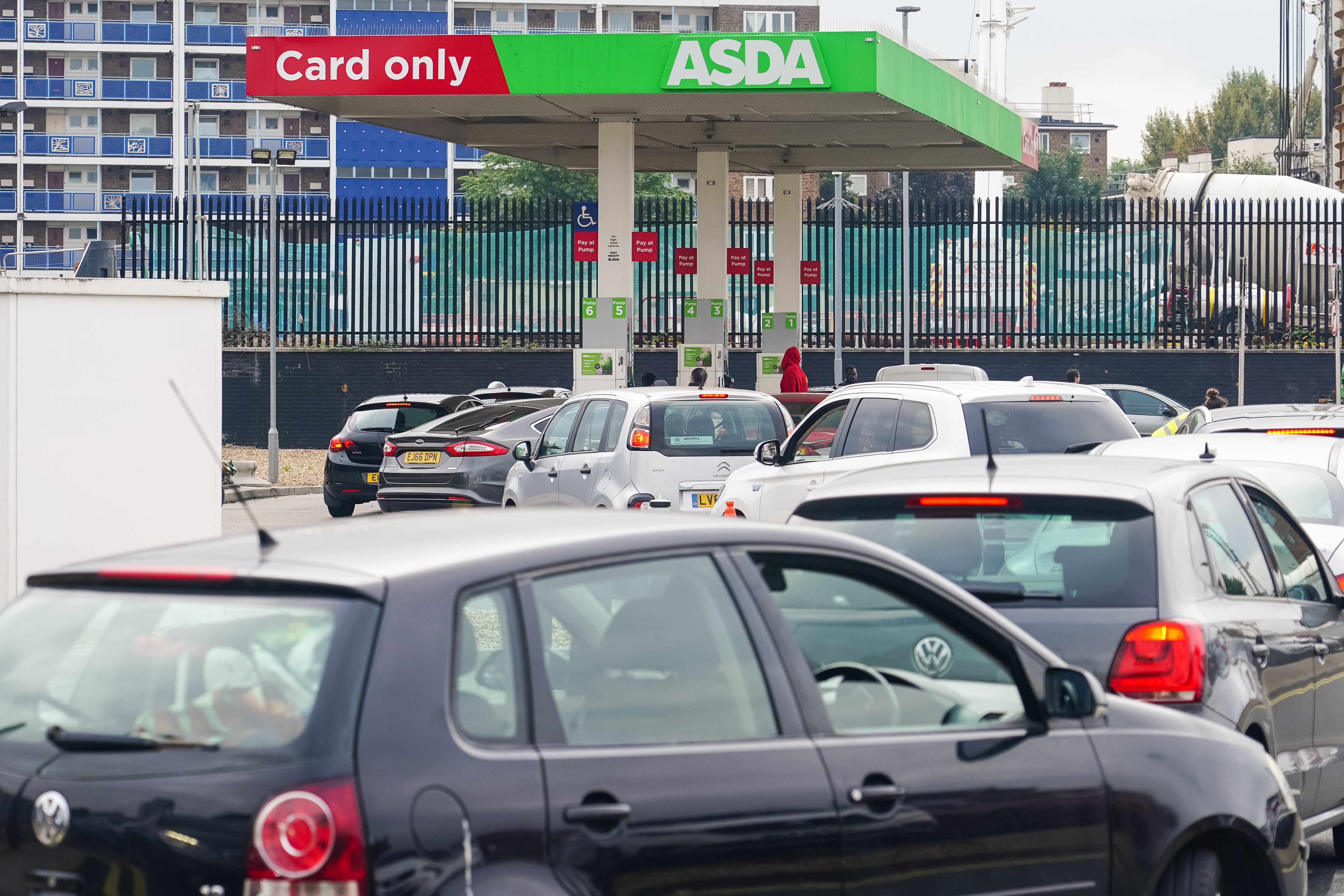 Cars queue for fuel at an Asda petrol station in south London amid continued panic buying (Dominic Lipinski/PA)
