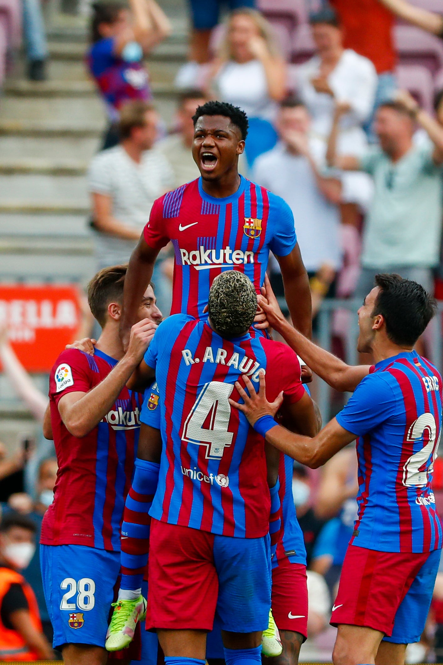 Ansu Fati is held aloft by his Barcelona team-mates after scoring on his return from injury (Joan Monfort/AP)