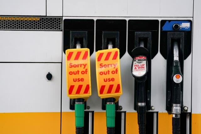 <p>Fuel pumps out of use at a deserted Shell petrol station forecourt in Warwick (Jacob King/PA)</p>