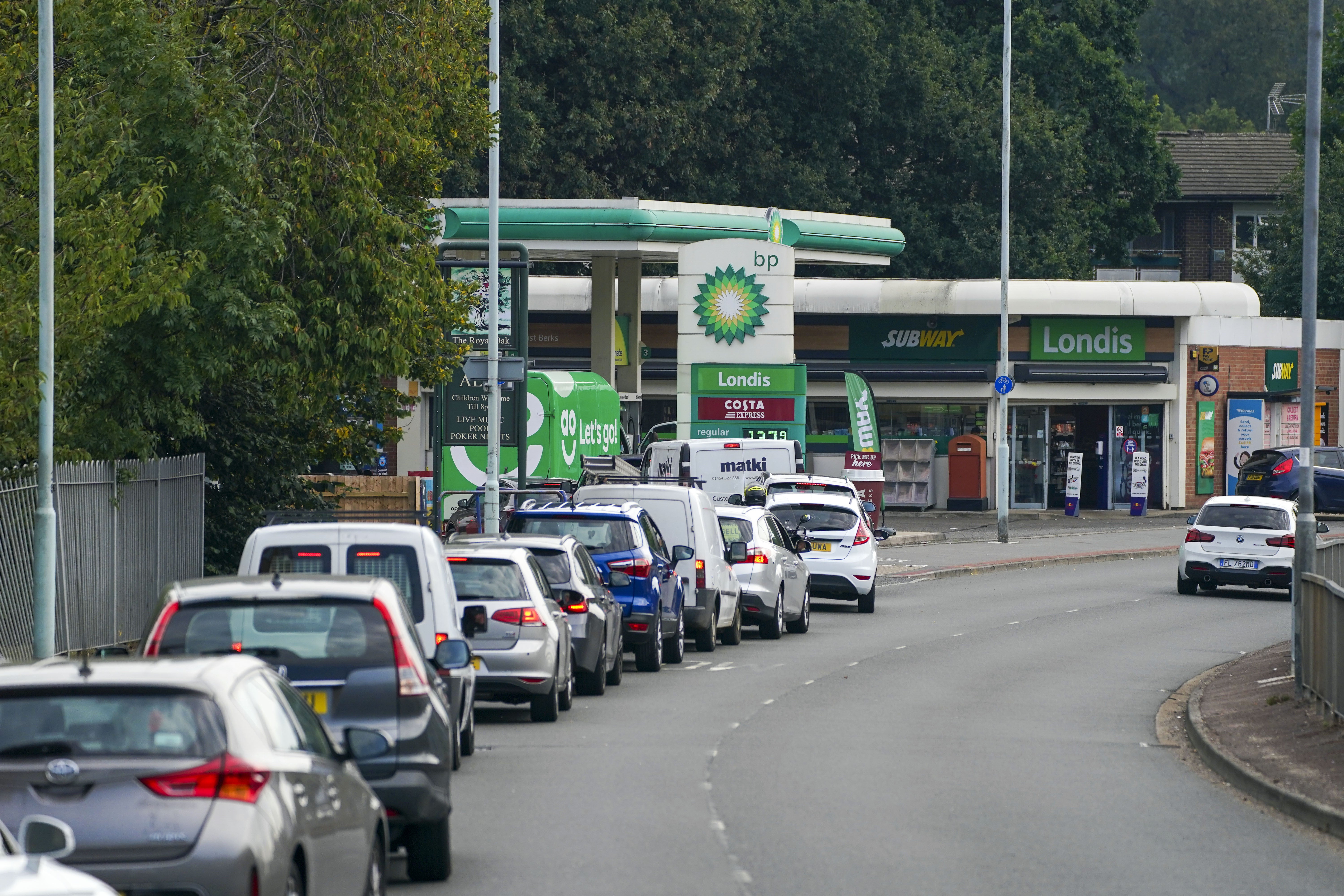 Cars queue for fuel at a BP petrol station in Bracknell, Berkshire