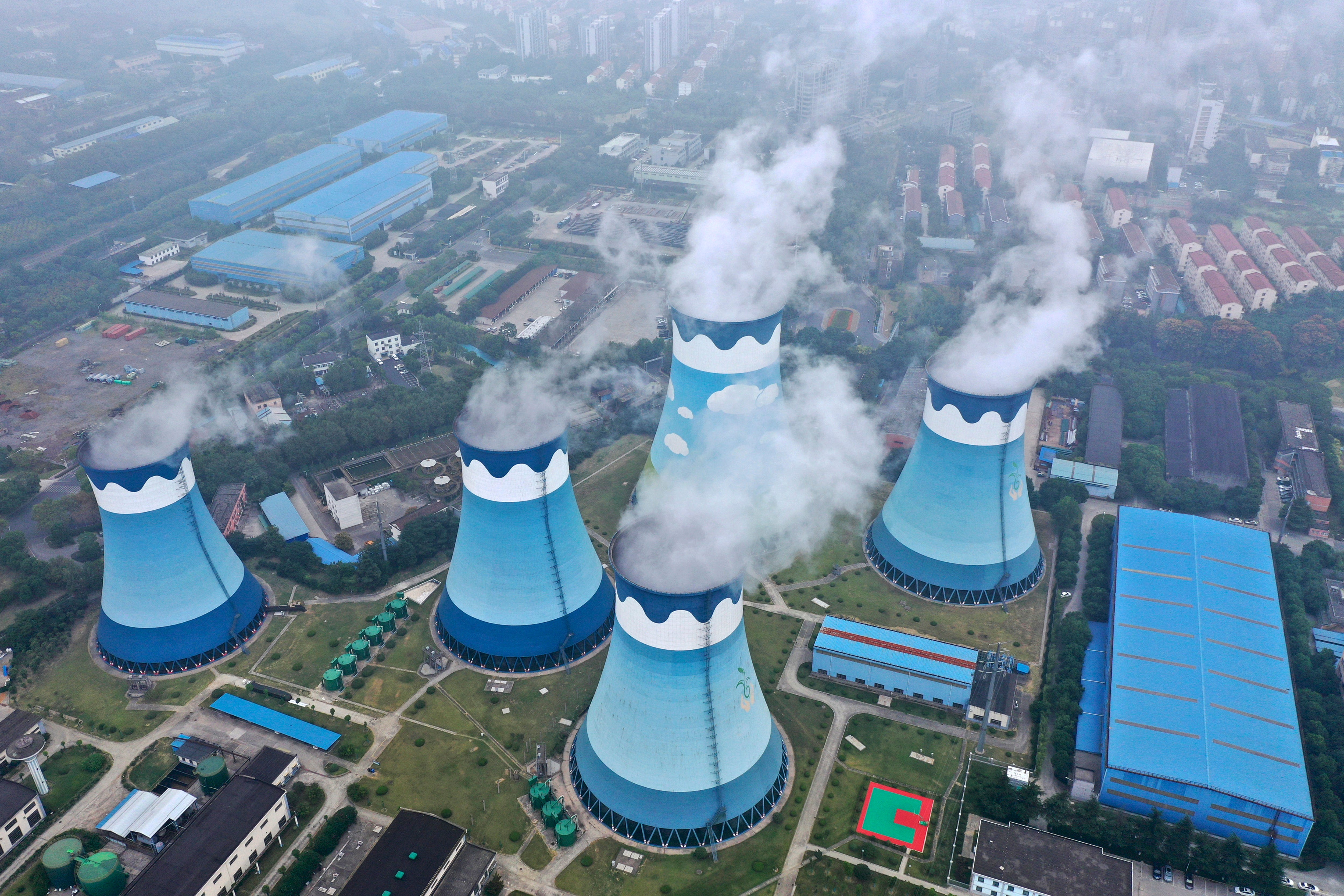Steam billows out of the cooling towers at a coal-fired power station in Nanjing in east China's Jiangsu province