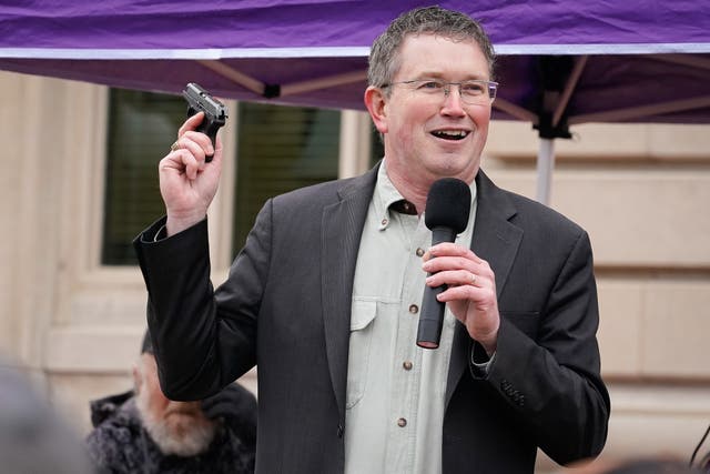 <p>Rep Thomas Massie (R-KY) draws a Ruger LCP handgun from his pocket during a rally in support of the Second Amendment on 31 January, 2020 in Frankfort, Kentucky</p>