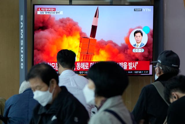 <p>South Koreans watch a news program showing a file image of the North’s missile launch </p>