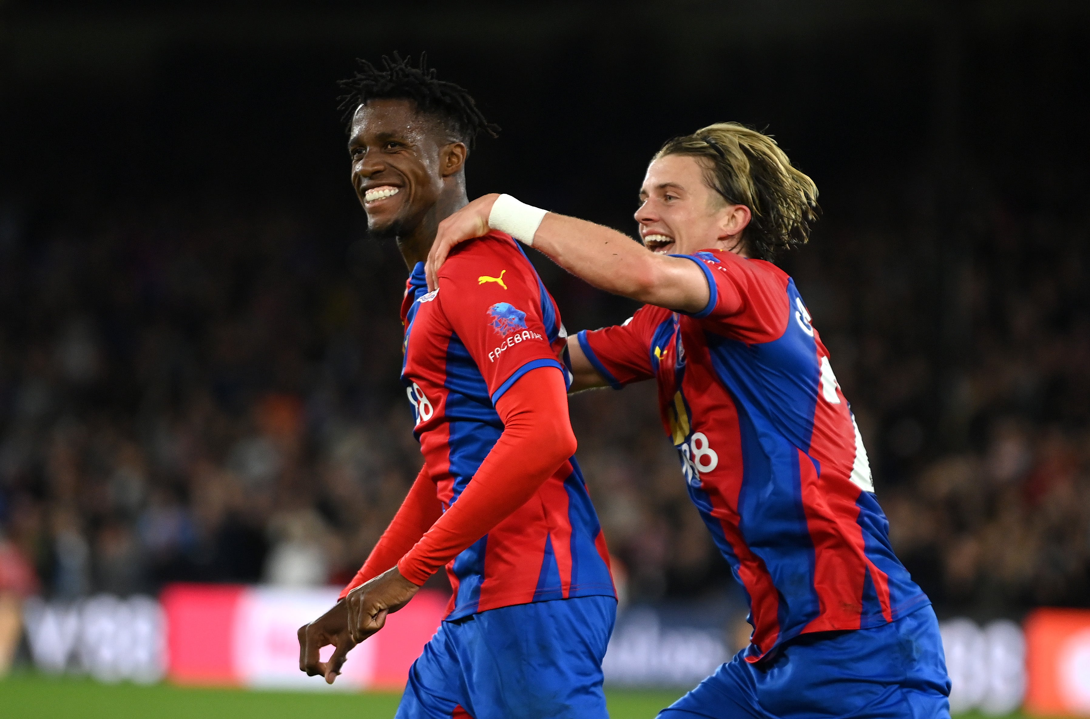 Crystal Palace’s Wilfried Zaha celebrates with Conor Gallagher