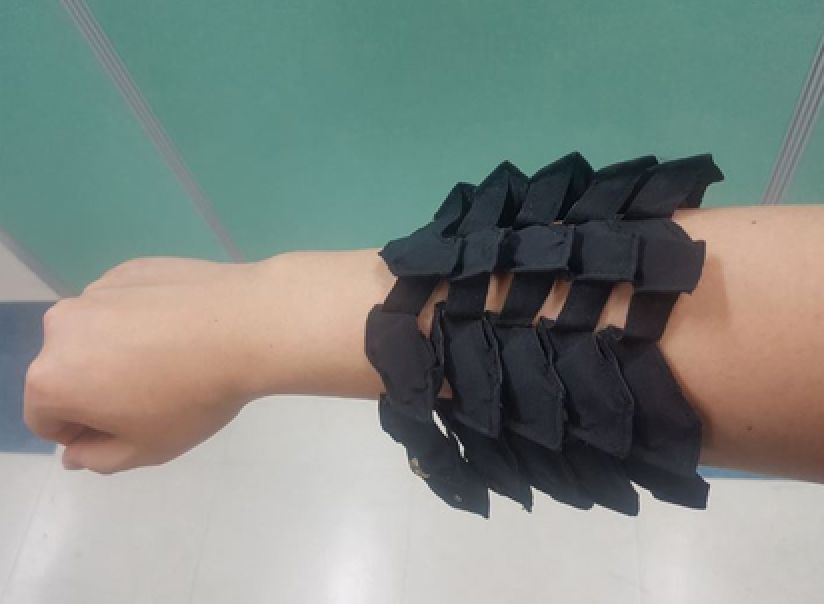 Flexible, stretchable battery developed by research team at KIMM shown on an individual’s arm and hand